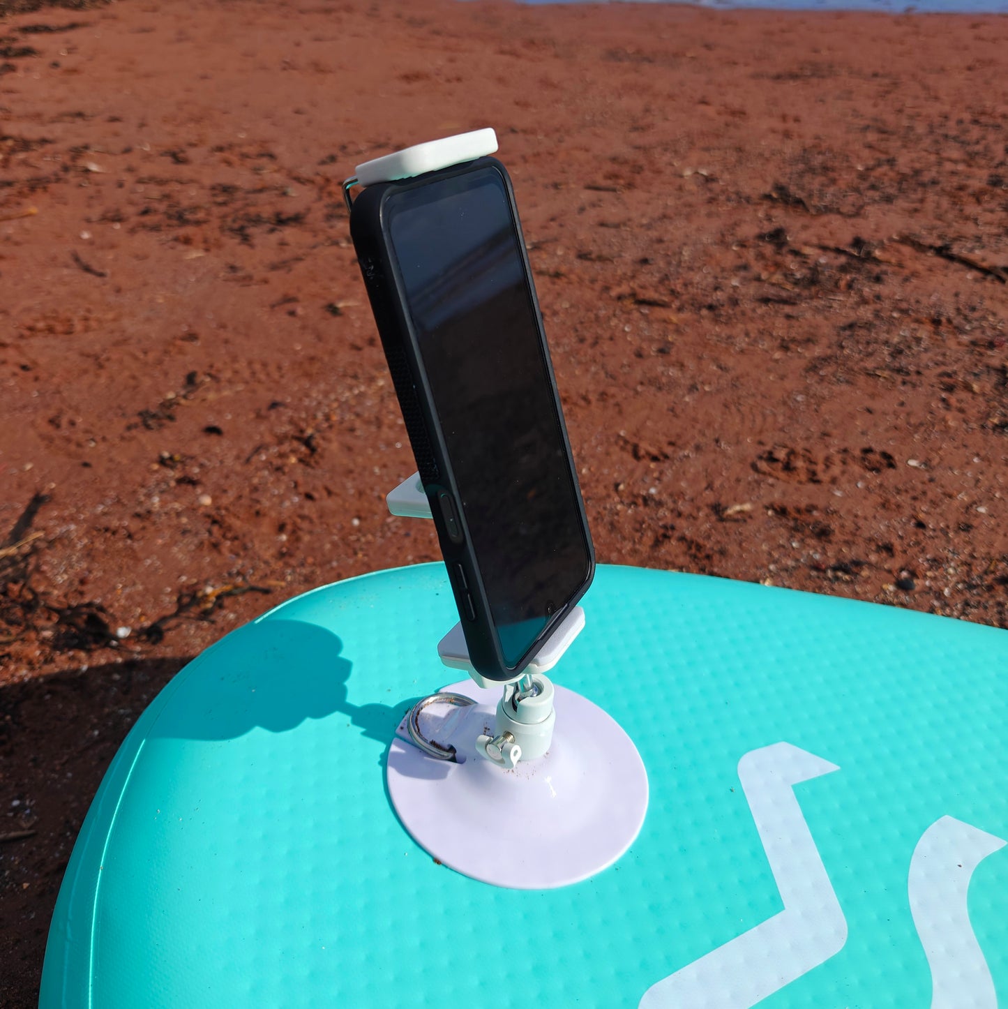 Phone mounted on a stand on paddleboard