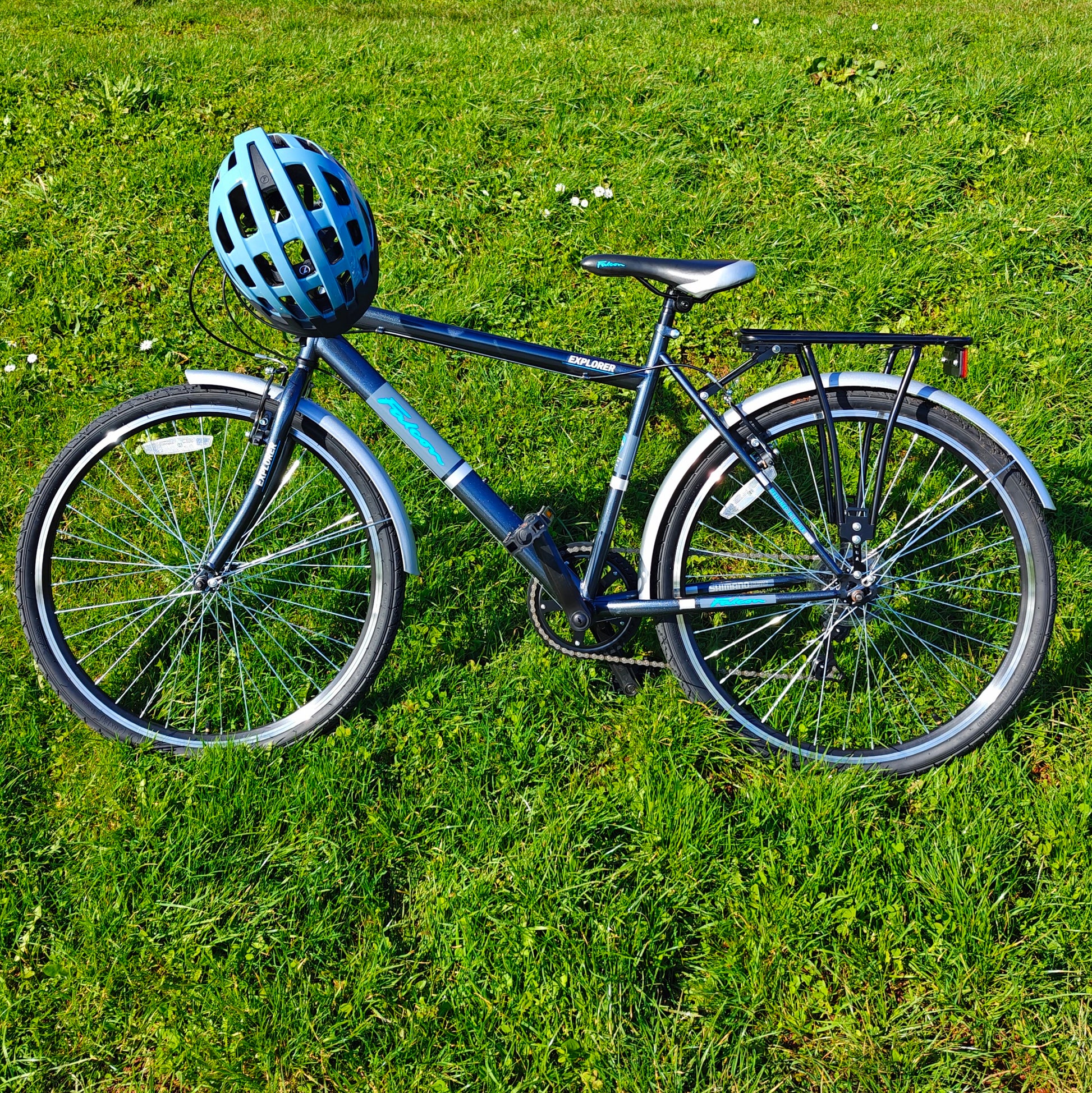 Bicycle with a helmet on a grassy field